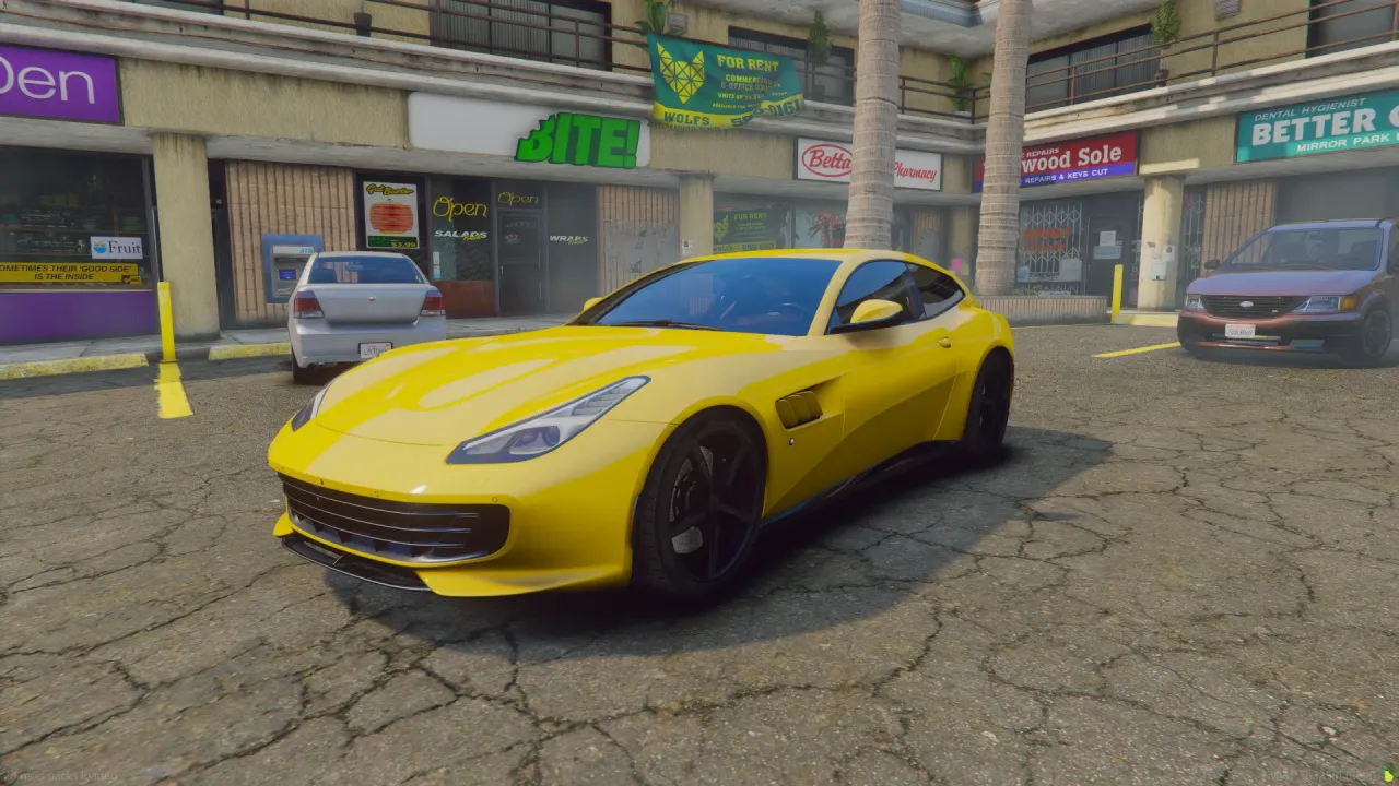 Ferrari GTC4Lusso FiveM car in yellow with black wheels, front three-quarter in a shopping plaza lot