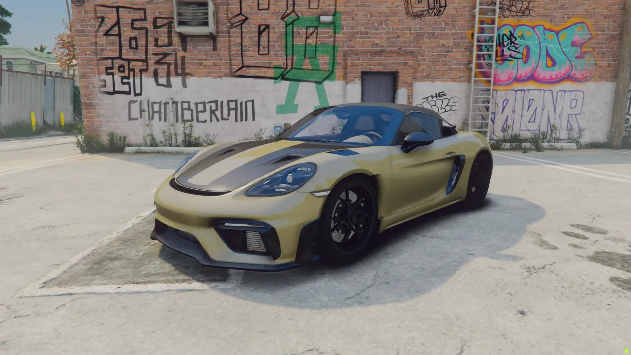Porsche 718 Spyder RS FiveM car in gold with black stripes, front three-quarter beside a graffiti wall