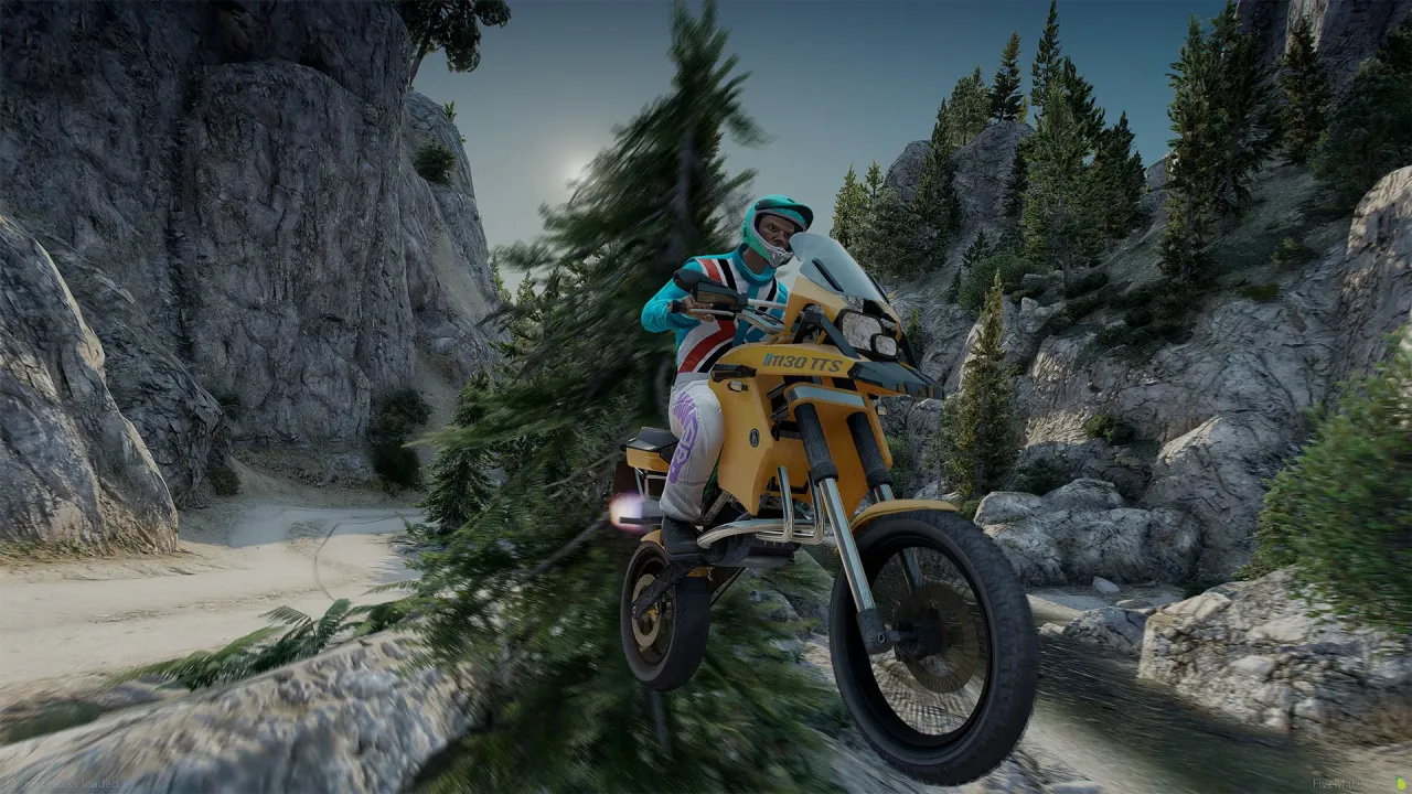 Ubermacht 1130 TTS in yellow jumping a rocky mountain trail with a rider in a teal and red suit