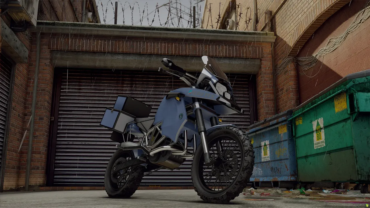 Ubermacht 1130 TTS front three-quarter view in blue with rugged tires by a shutter door and dumpsters