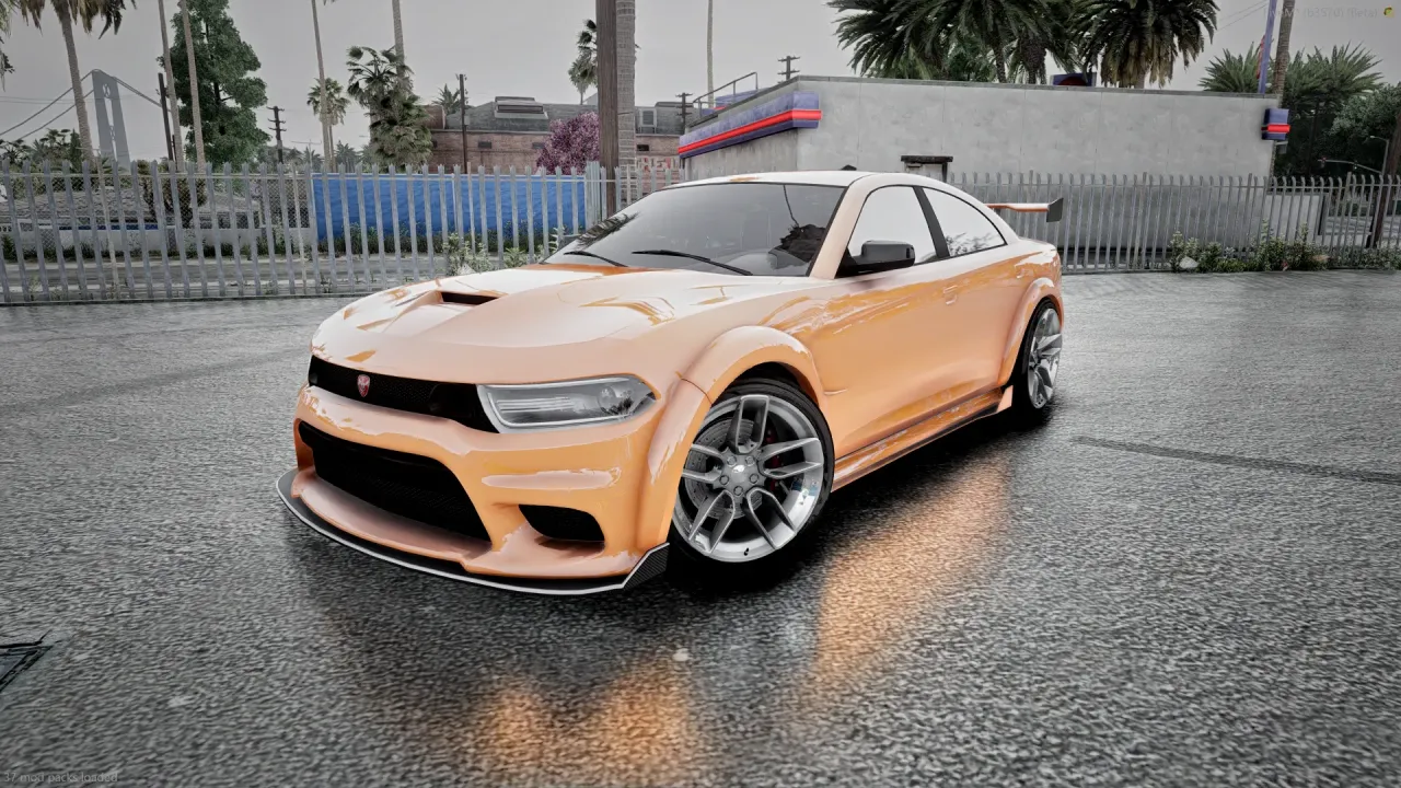 Buffalo TTX in metallic orange with chrome wheels on wet asphalt, front three-quarter view by a fence