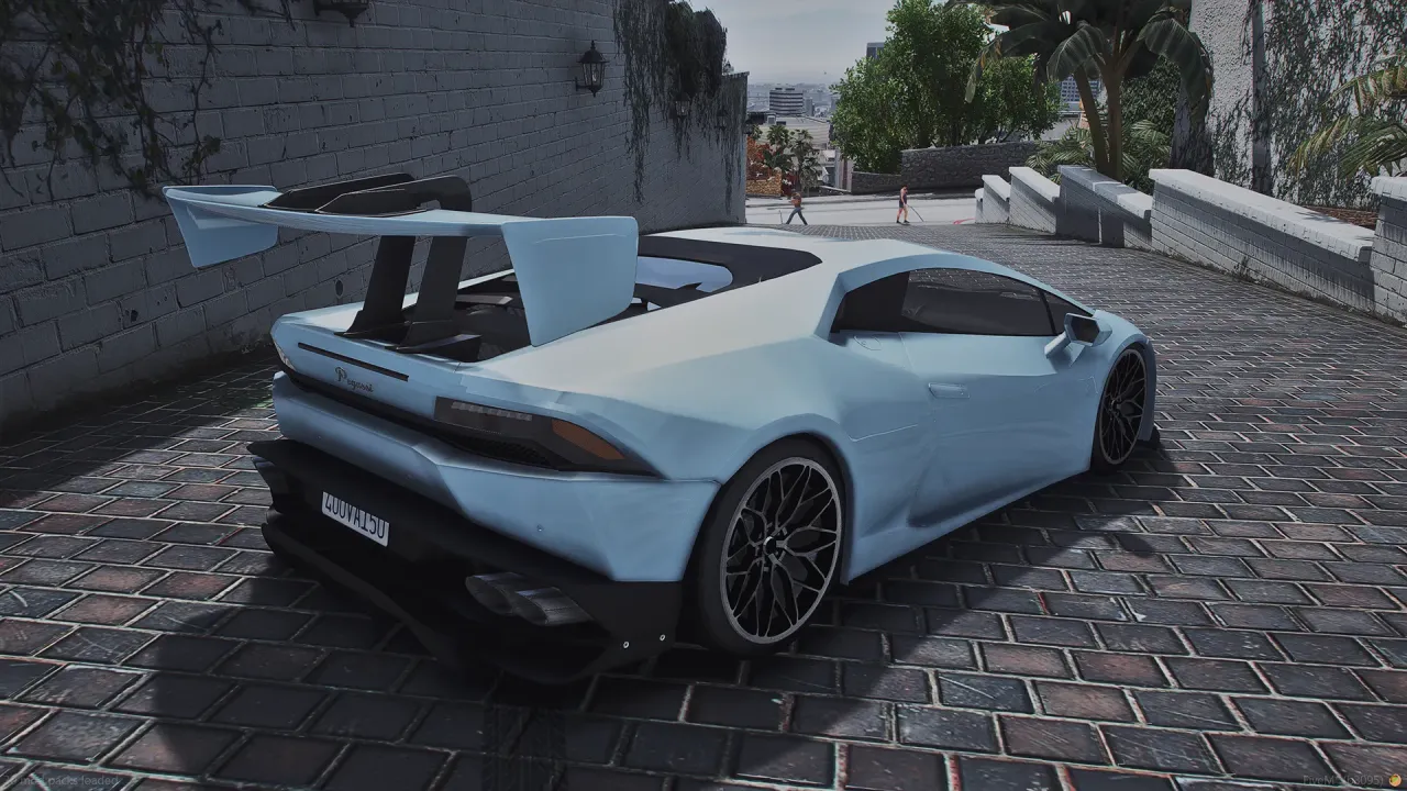 Pegassi Tempesta in powder blue with a large rear wing, rear three-quarter view on a brick driveway