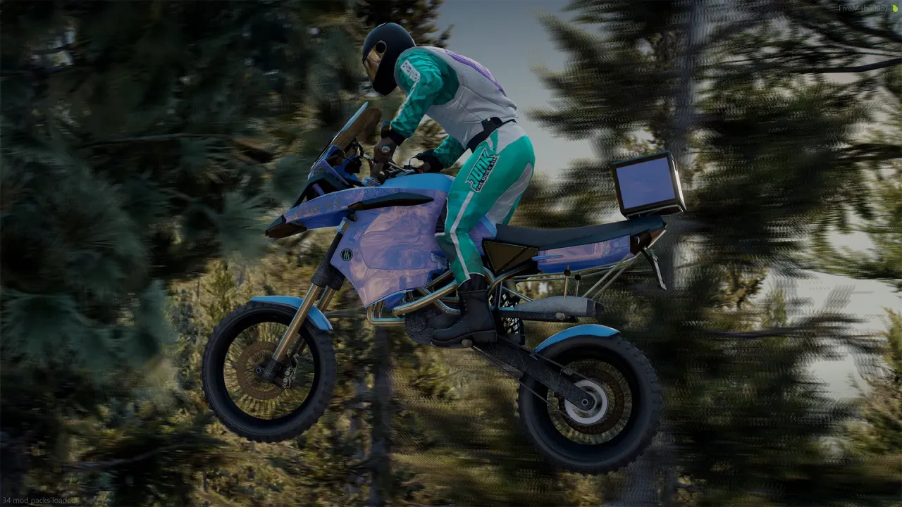 Ubermacht 1130 TTS in blue ridden mid-air past pine trees by a rider in a teal and white suit