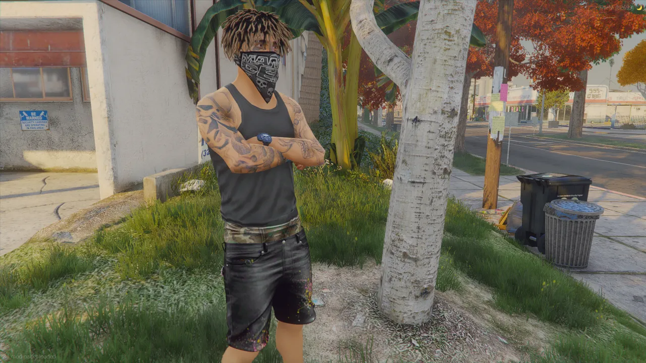 Salvagoon ped wearing a bandana mask and black tank top, tattooed arms folded on a FiveM sidewalk