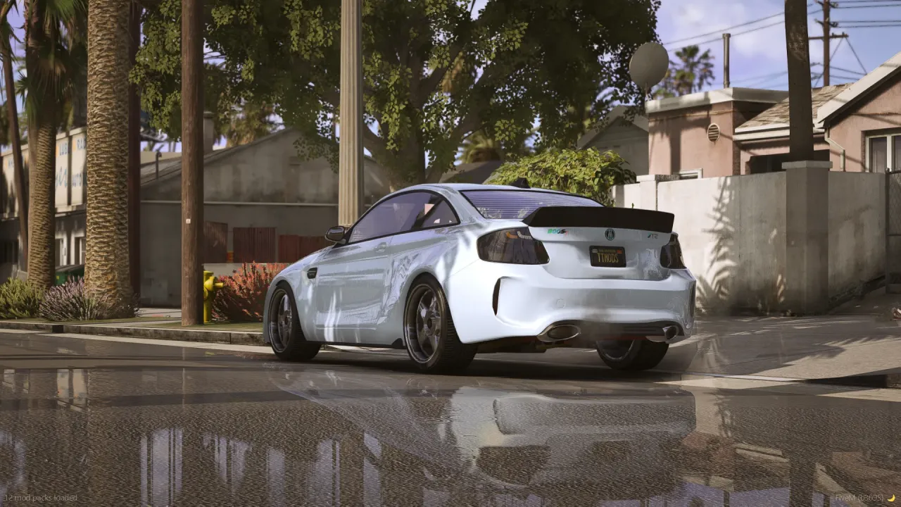 Cypher T2 in white with a black ducktail spoiler, rear three-quarter view on a wet suburban street
