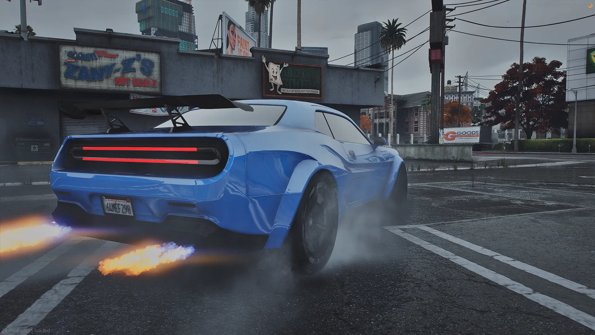 Bravado Gauntlet Hellfire TTS in blue with flames from the exhausts and tire smoke, rear three-quarter view