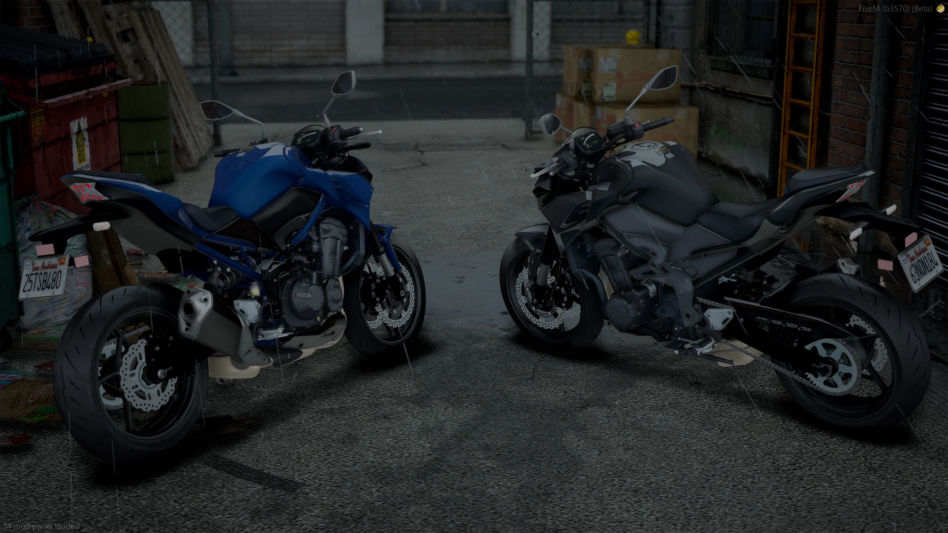 Kawasaki Z900 (2021) blue and black pair from the rear in a wet backstreet with stacked boxes
