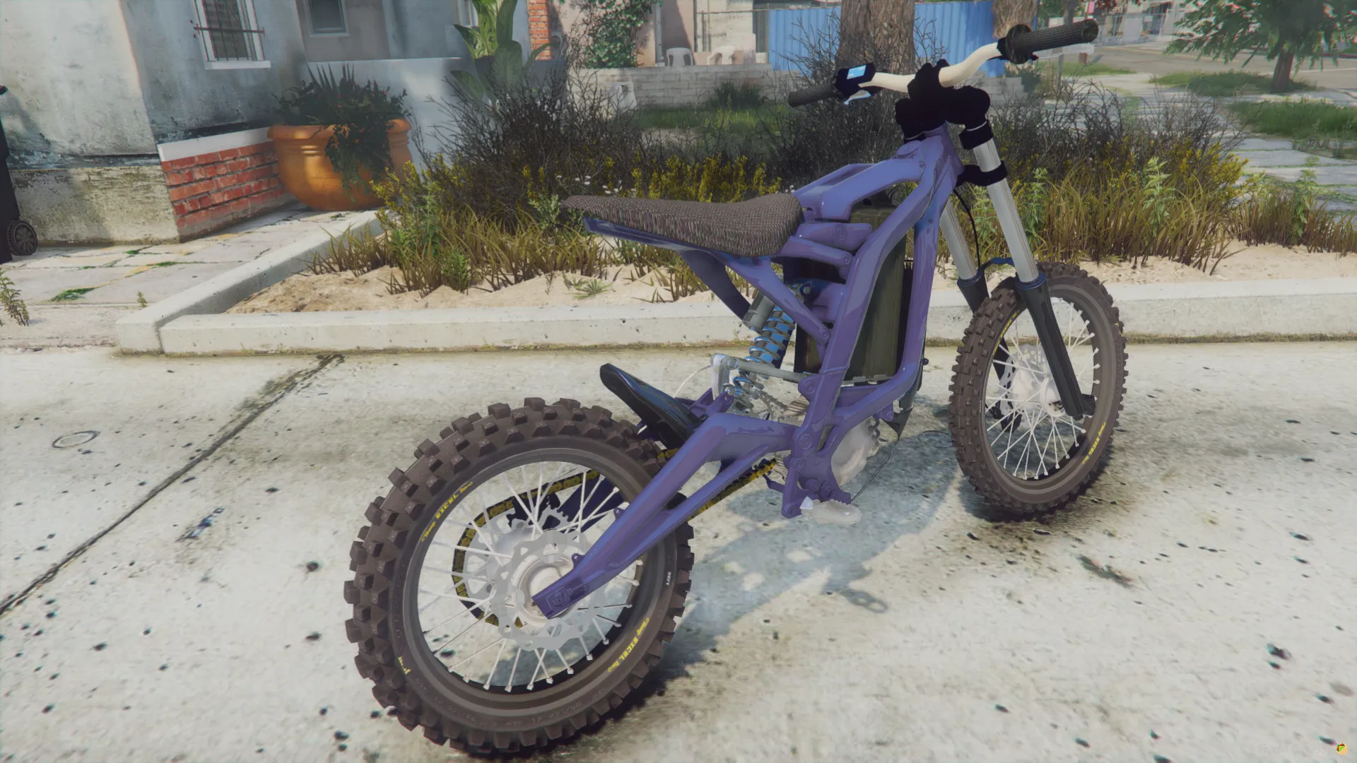 Sur-Ron Light Bee X 2023 side view of the blue frame and white fork legs on a street by houses