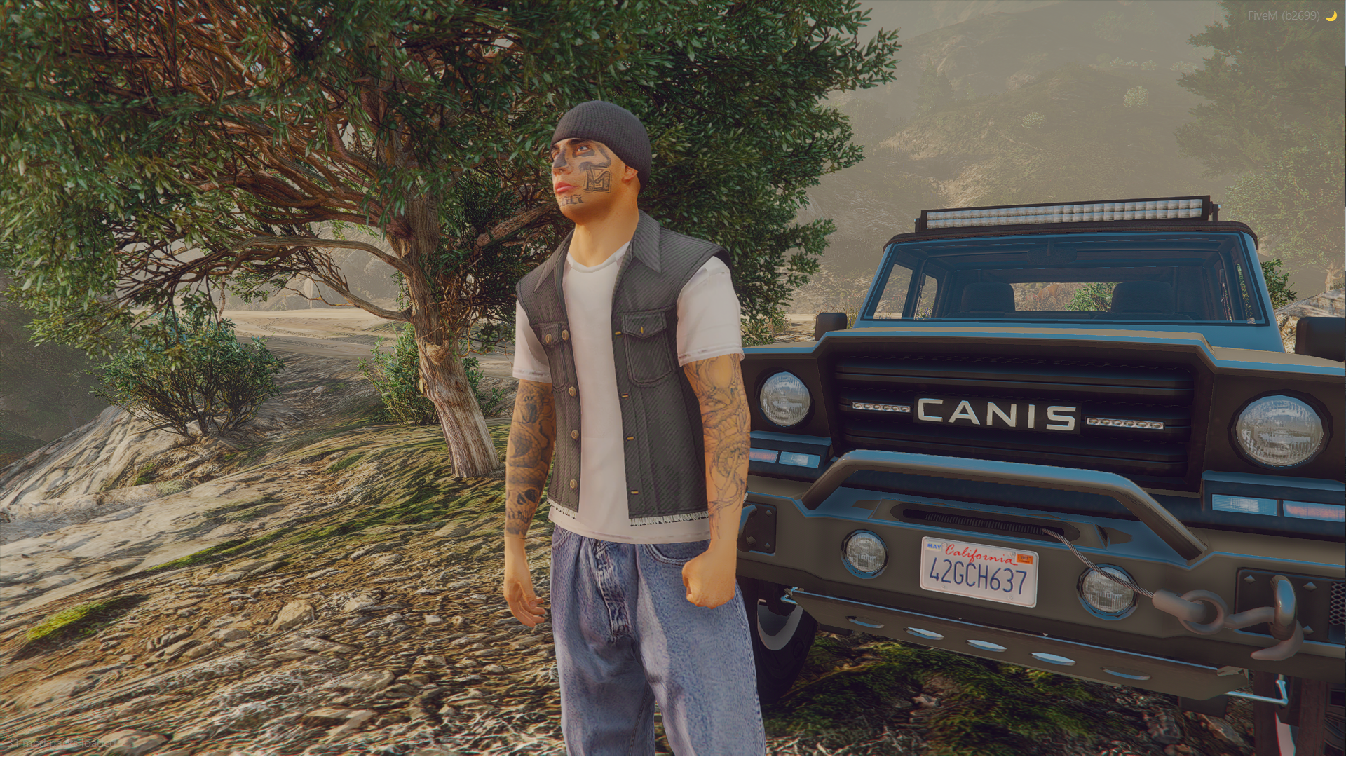 Salvagoon in a beanie, leather vest and jeans standing beside an off-road truck in the woods