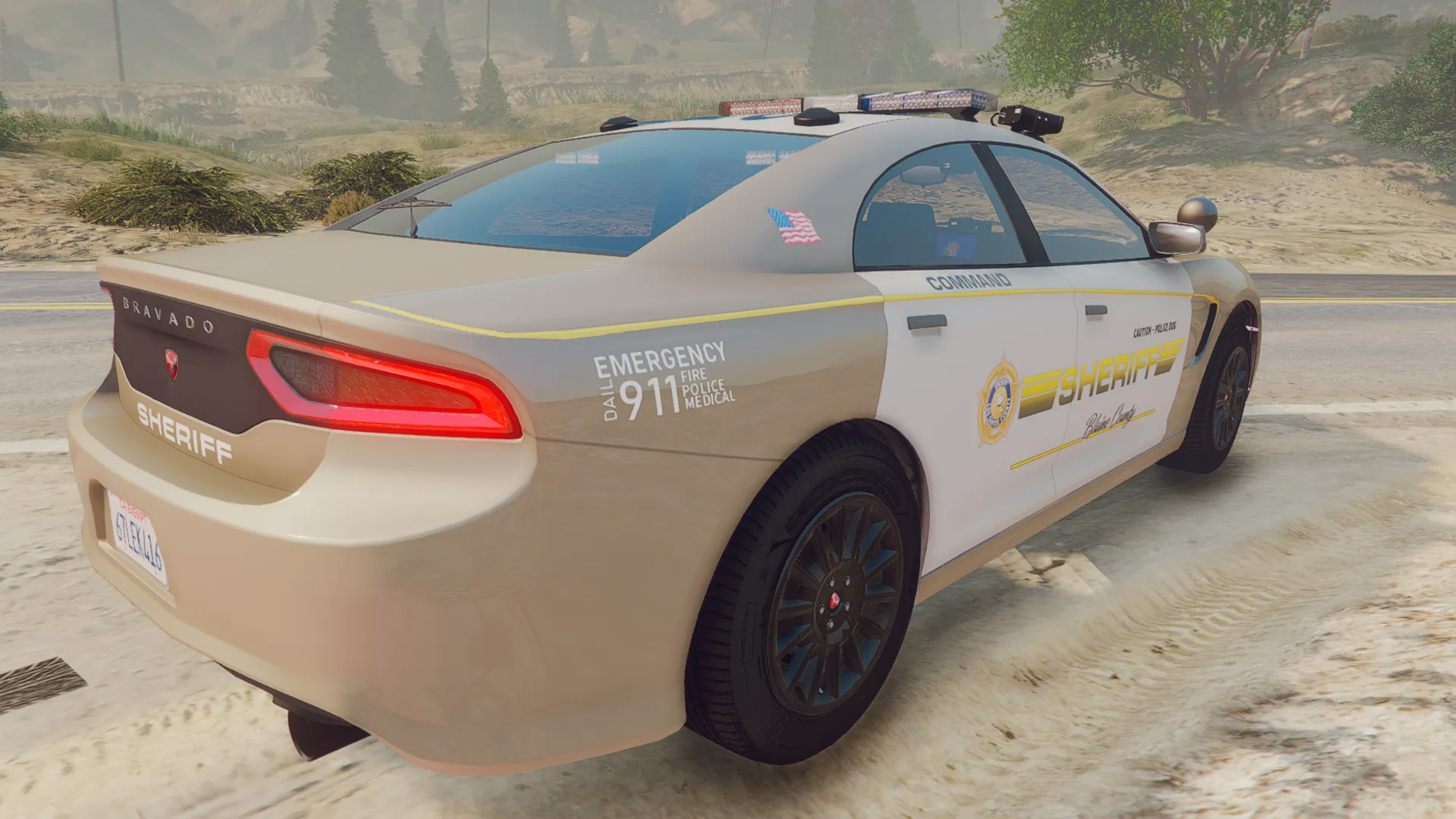 Police Buffalo V1 in tan and white Sheriff Command livery, rear three-quarter view on a sandy road