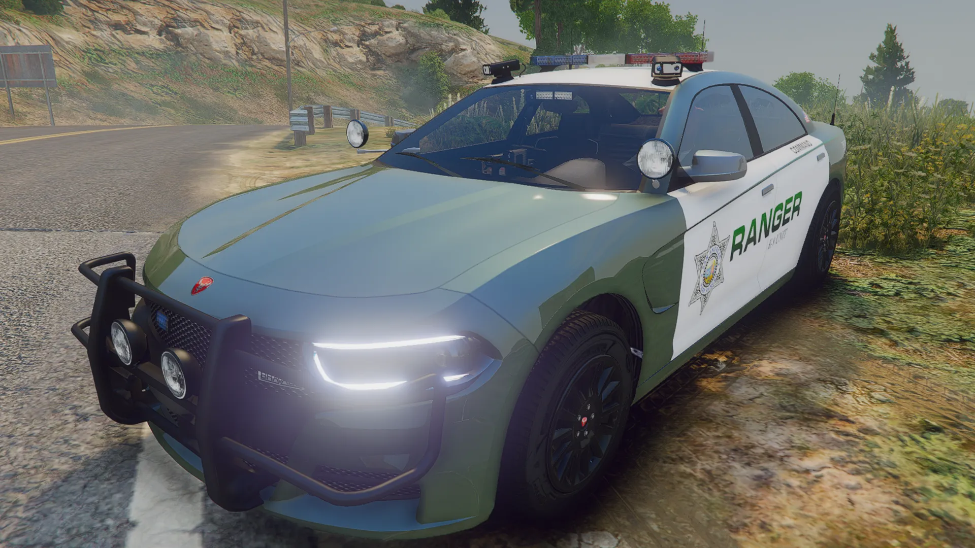 Police Buffalo V1 in green and white Ranger livery with push bar lights, front three-quarter on a rural roadside
