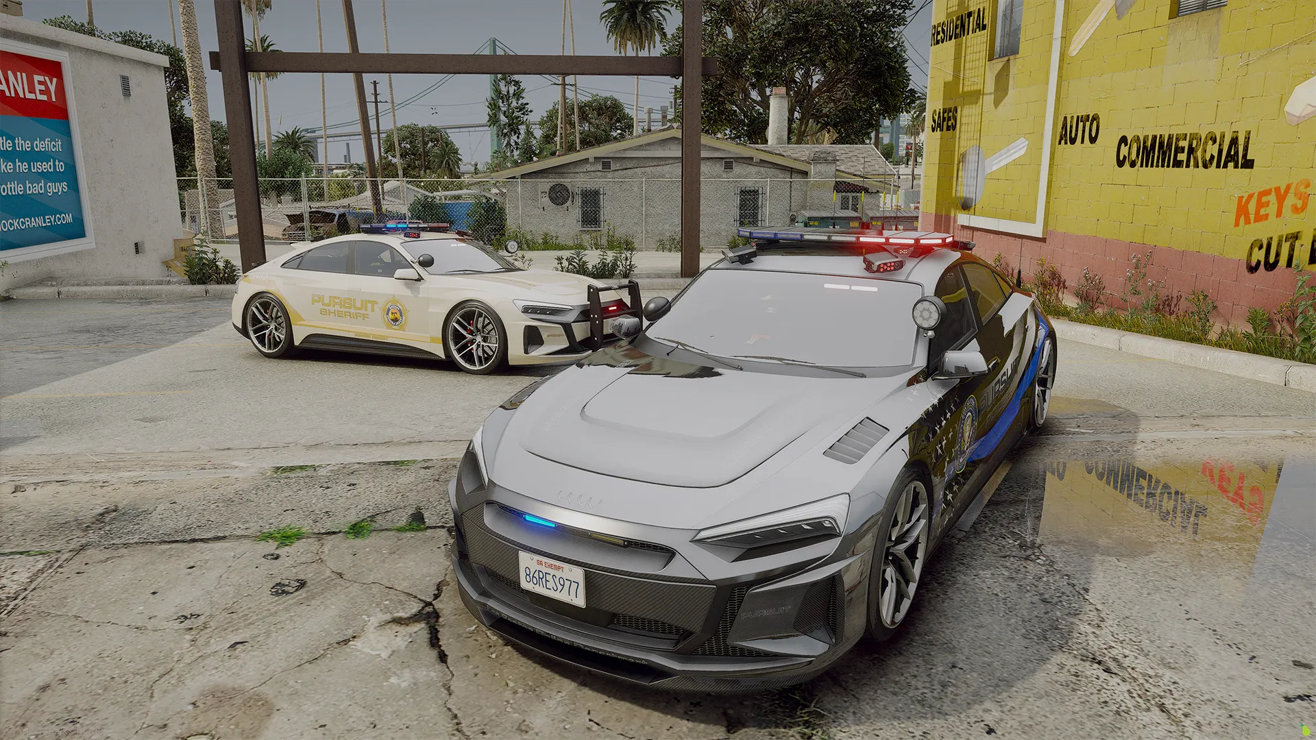 Obey Omnis e-GT in grey trooper livery with push bar parked beside a white sheriff unit on a sunny street