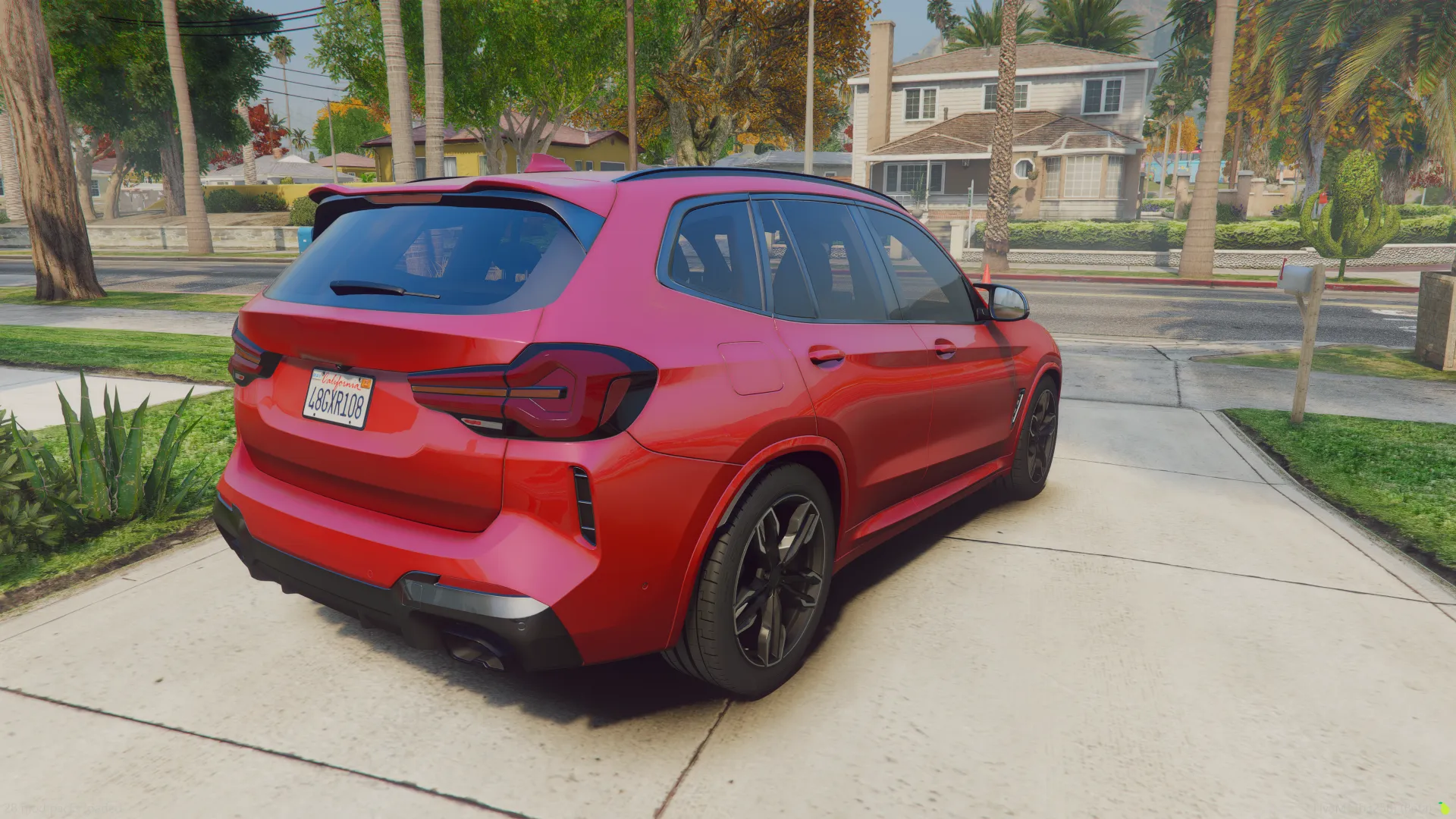 BMW X3 2023 rear three-quarter view in red on a driveway with palm trees and houses behind
