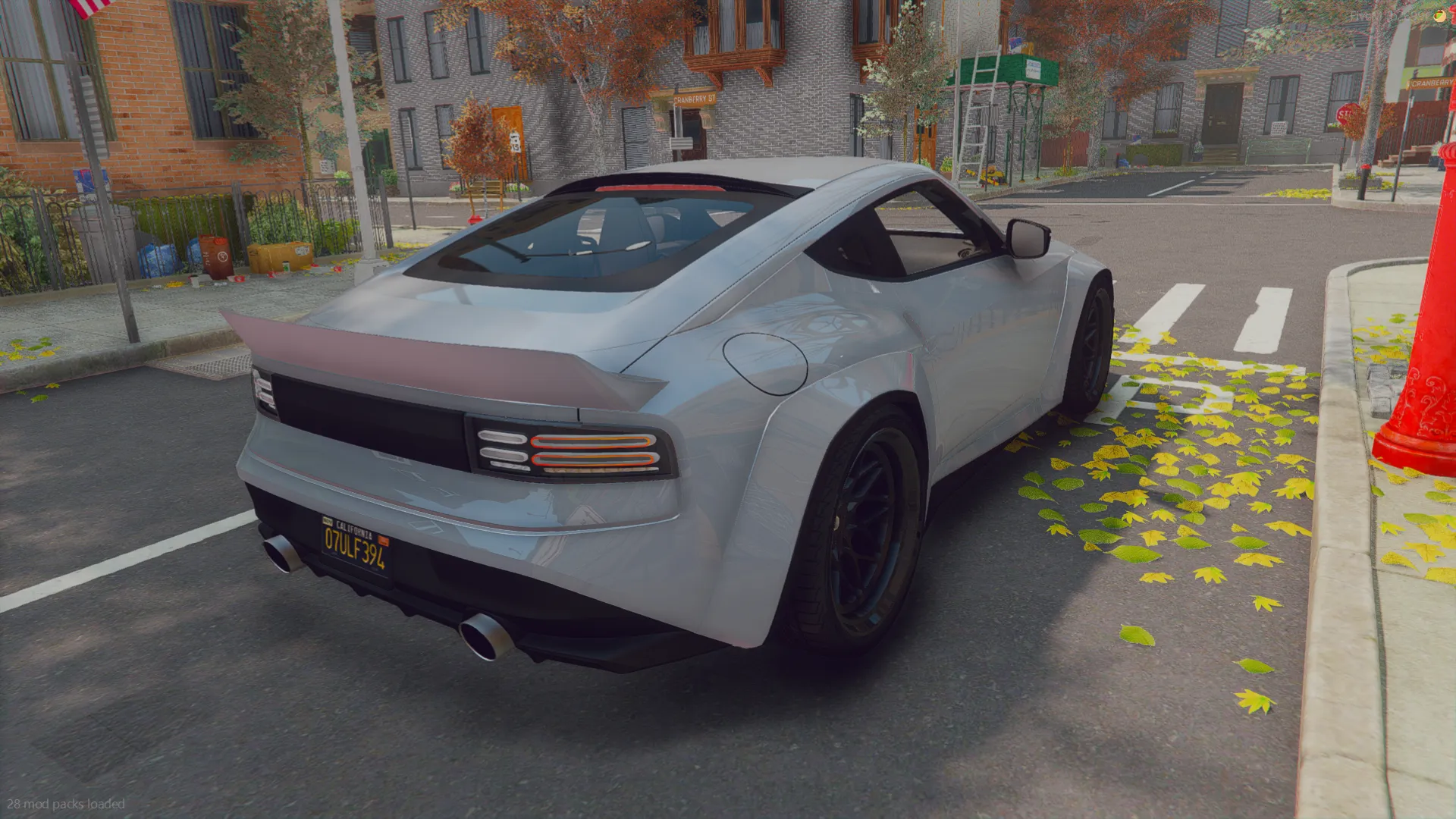 2022 Nissan 400Z V2 rear three-quarter view with twin exhausts and ducktail spoiler on a leaf-strewn street