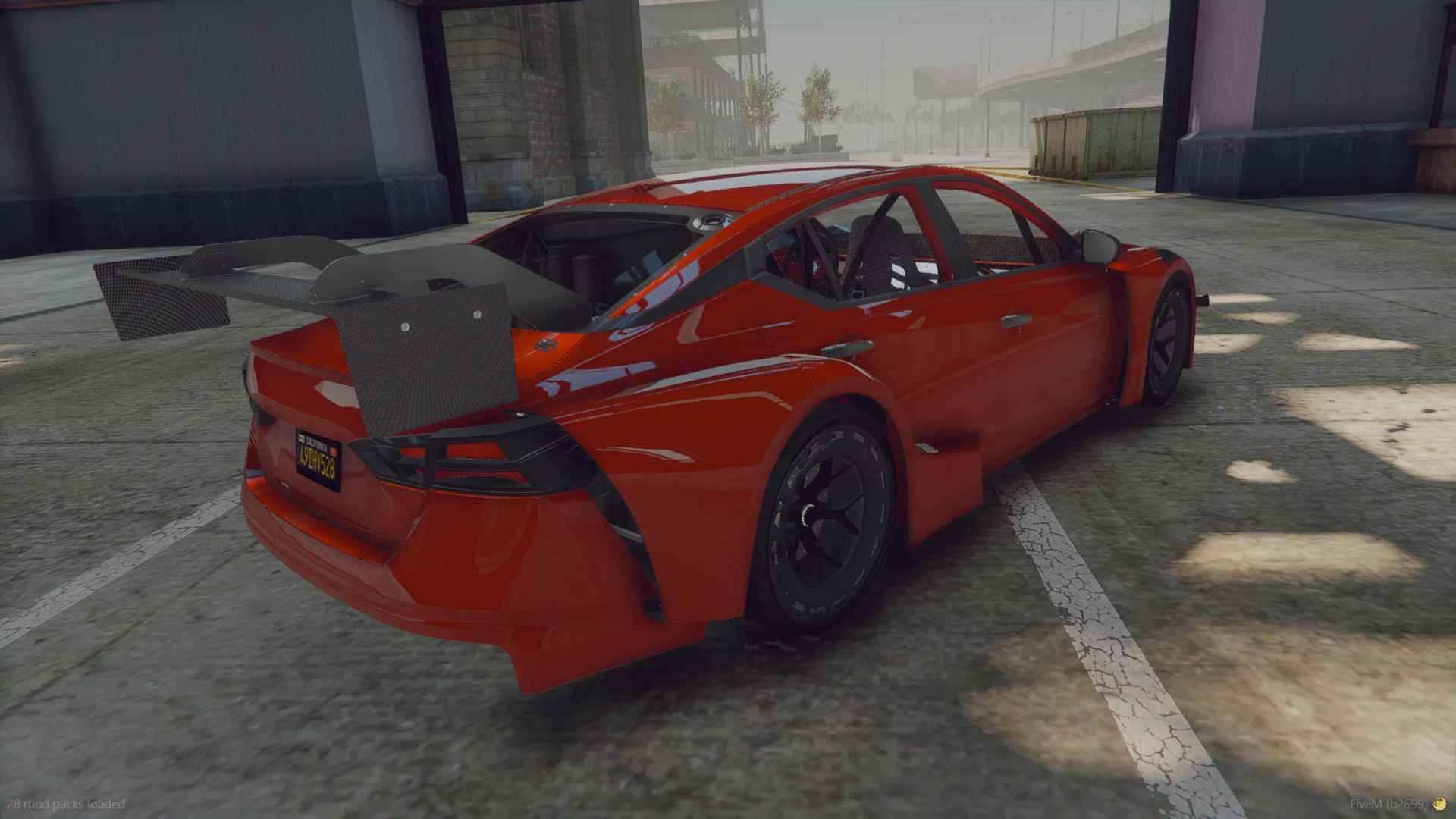 Nissan Altimaniac 2021 rear three-quarter view in red with large carbon rear wing and stripped cabin roll cage