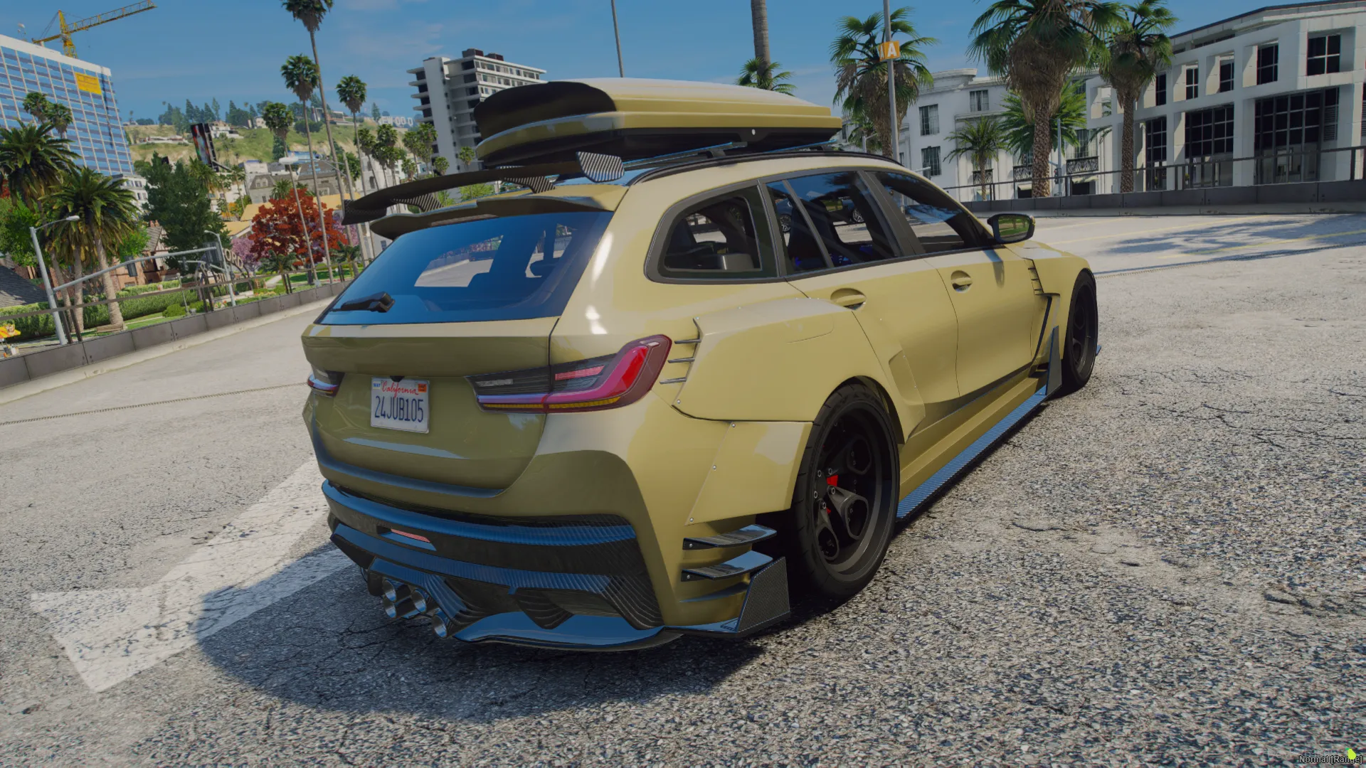 BMW M3 Touring G81 2022 rear three-quarter view in olive gold with a roof cargo box and red calipers