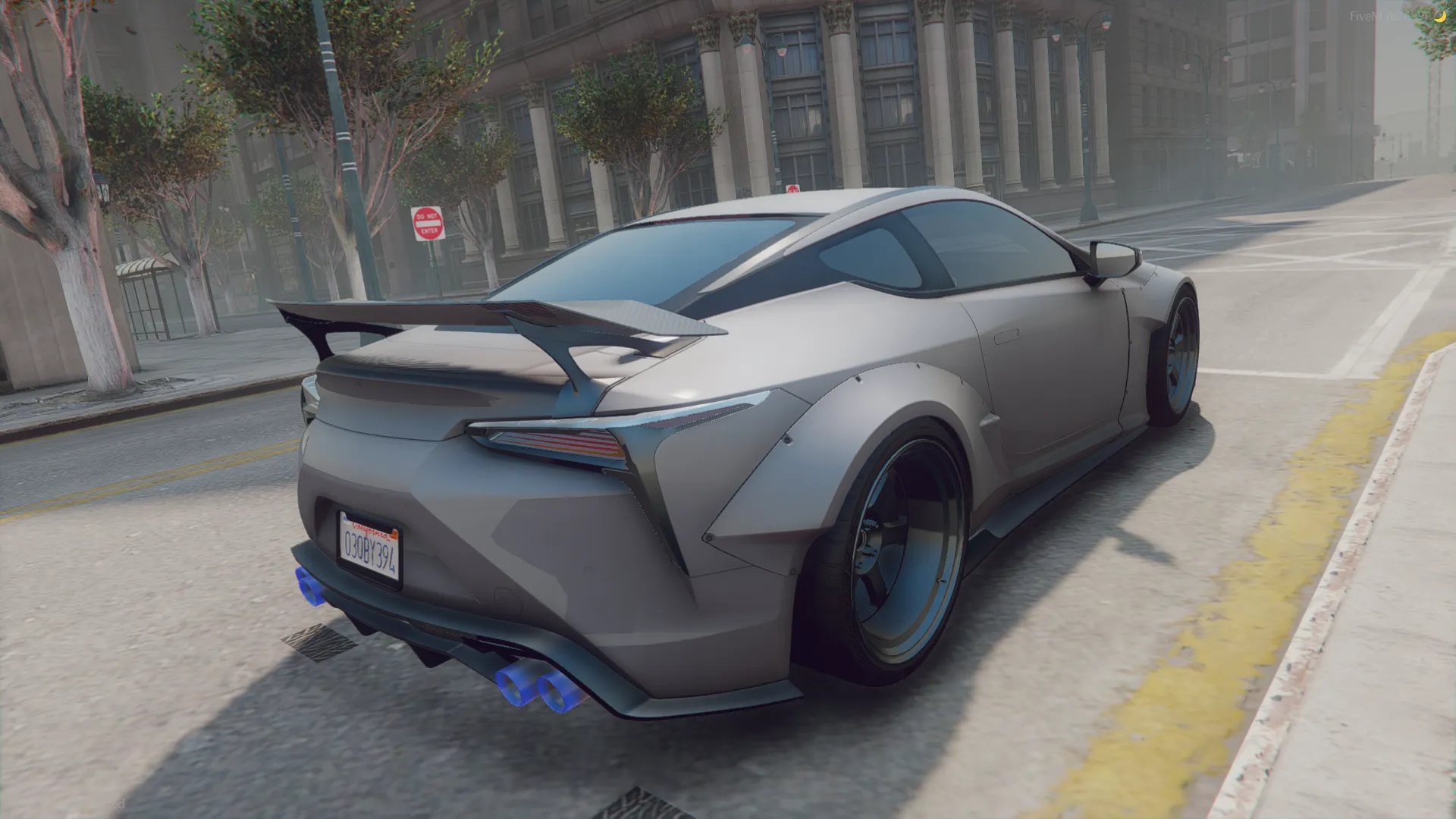 A FiveM GTA5 car, the Lexus LC 500h Exclusive 2019 from the rear, wing raised and blue exhaust tips by a yellow curb