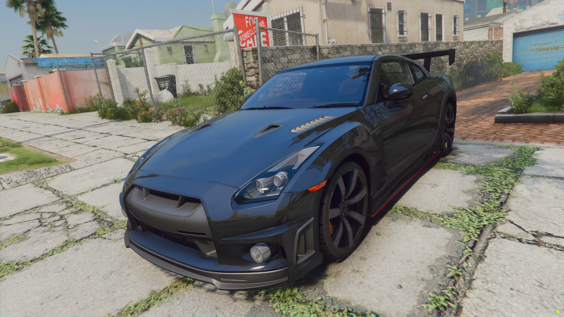 Nissan GT-R R35 FiveM car in dark grey with orange brake calipers, front three-quarter view on a cracked paved yard