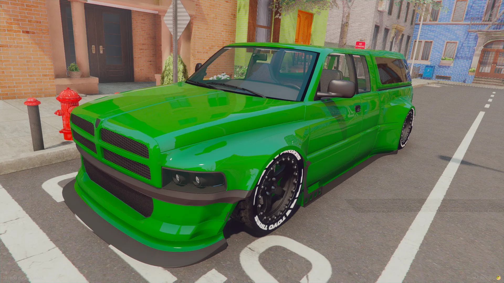 Dodge Ram v0 2015 FiveM pickup in green with white-lettered tires, front three-quarter view in a parking bay