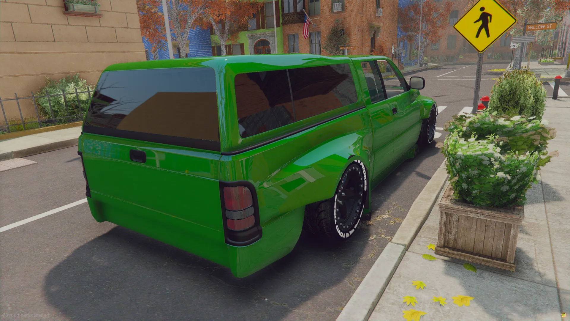 Dodge Ram v0 2015 rear three-quarter view with a green bed cap beside a sidewalk planter