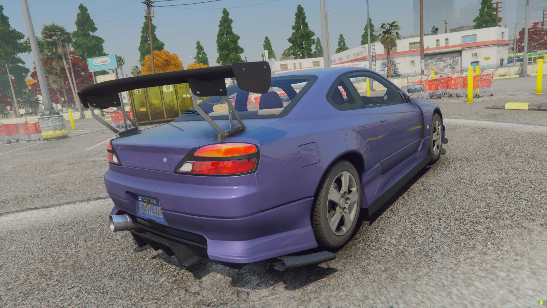 Behind the Nissan Silvia S15, a FiveM car raises a tall GT wing over a side exhaust in an open parking lot