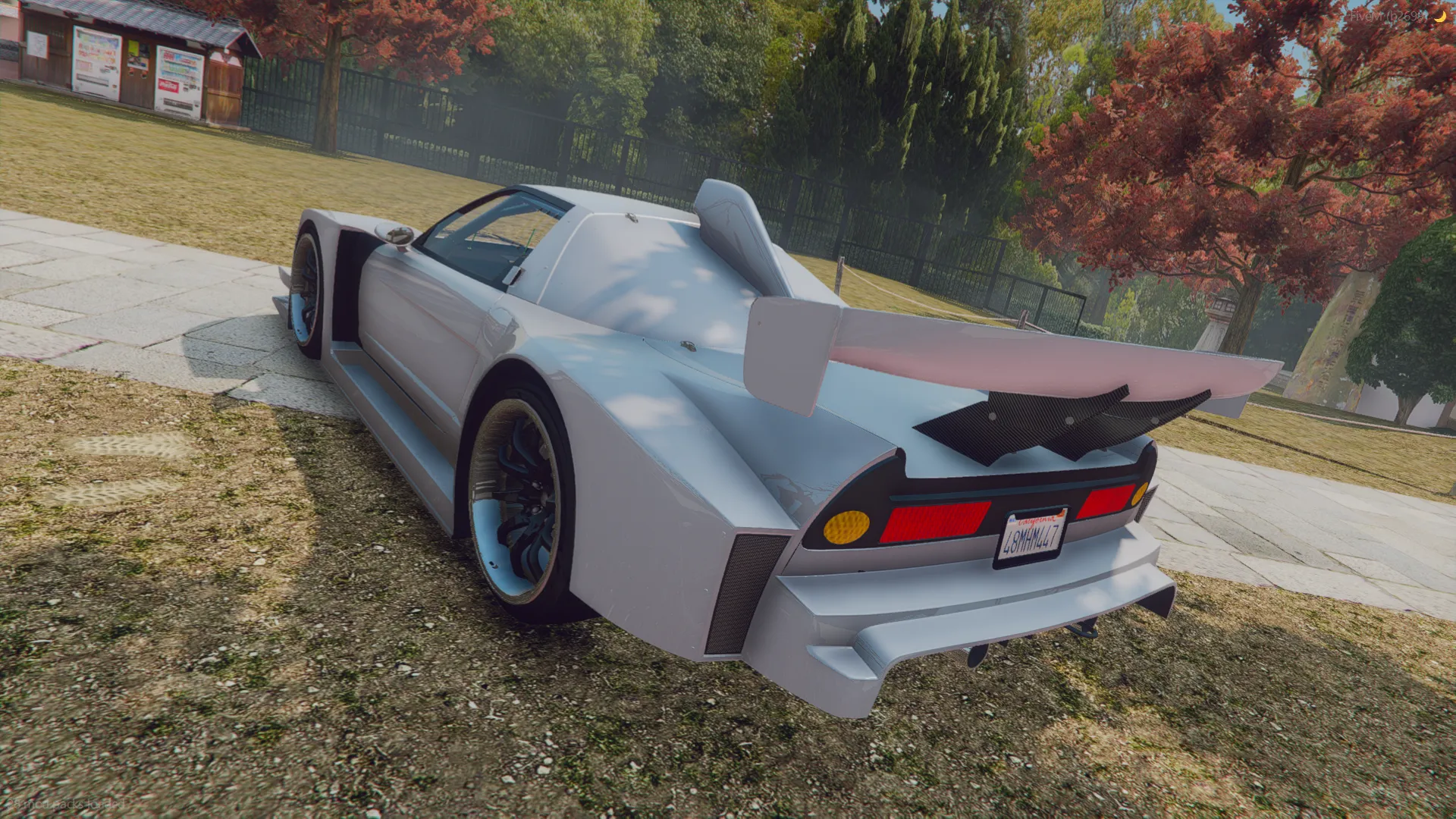HONDA GT500 NSX 2006 rear three-quarter view with a large rear wing and shark fin on a grassy park path